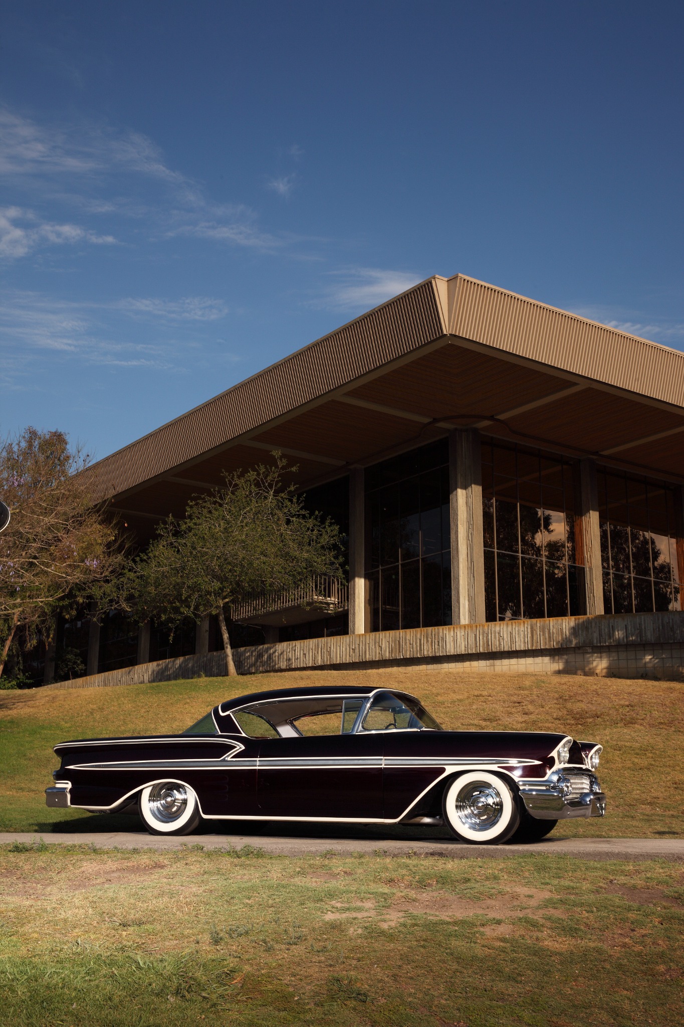 Burgundy custom Impala with cream accents and whitewall tires