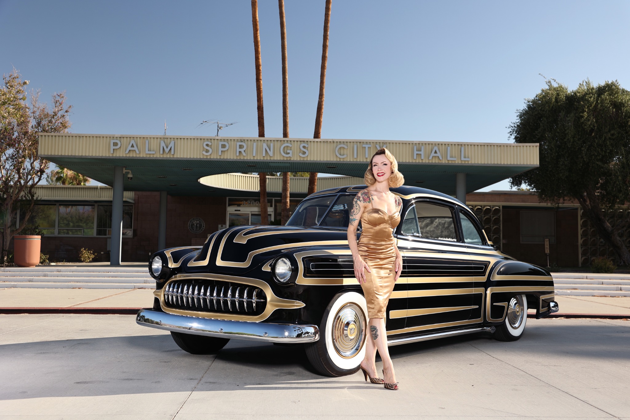 Black-and-gold custom with model, front three-quarter view